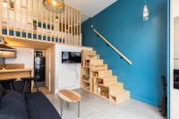 a living room with a blue wall and a stairway at DIFY Joseph Bonnet - Croix Rousse in Lyon