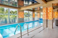 an indoor pool in a house with windows at Osrodek Wypoczynkowy Lesniczówka &amp; Elias SPA in Istebna