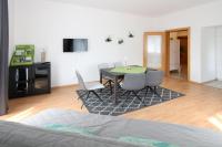 a living room with a dining room table and chairs at Steira-Studios Leibnitz in Leibnitz