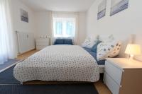 a bedroom with a bed and a blue couch at Steira-Studios Leibnitz in Leibnitz