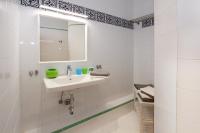 a white bathroom with a sink and a mirror at Steira-Studios Leibnitz in Leibnitz