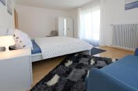 a bedroom with a bed and a blue couch at Steira-Studios Leibnitz in Leibnitz