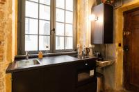 a kitchen with a sink and a window at DIFY Platiere - Hotel de Ville in Lyon
