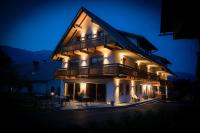 a lit up house at night with lights at House Troha - Rooms &amp; Apartments in Bled