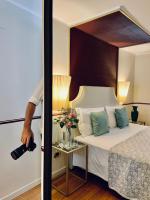 a man taking a picture of a bed with a camera at Hotel Do Pozzi in Venice