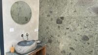 a bathroom with a stone sink and a mirror at Het Lichthuis in Zandvoort