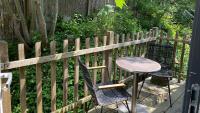 a table and chairs next to a wooden fence at Het Lichthuis in Zandvoort