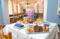 a table with a plate of food on it at Hotel Pineta in Ischia