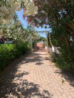 A garden outside Sardegna Costa Corallina Appartamento Luxury Vista Mare in splendido villaggio - IUN R6511