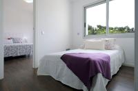 A bed or beds in a room at Villa Mont Rodó con piscina y jardín privado - Pet Friendly
