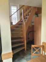 a stairway in a home with a wooden staircase at Ferienhaus am Wasserturm Angermünde in Angermünde