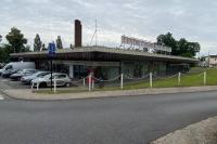 a building with cars parked in a parking lot at Studio de charme - calme, discret &amp; cosy - 3&#39; RER in Évry-les-Châteaux