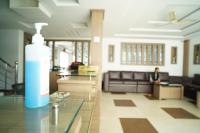 a living room with a large bottle of water on a counter at North Centre in Cochin