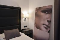 A bed or beds in a room at Hotel Palma