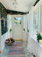 a hallway with a white door and flowers on the wall at Boutique Villa MAMELFA in Tiheda