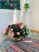 a bouquet of flowers in a vase on a rug at Boutique Villa MAMELFA in Tiheda
