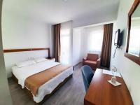 A bed or beds in a room at Karden Otel