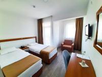 A bed or beds in a room at Karden Otel