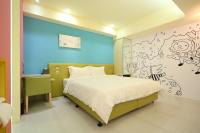 a bedroom with a large bed with a blue wall at The Fantasy Apartment in Hualien City