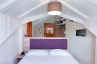 A bed or beds in a room at Hotel Aggelos Kefalonia