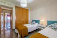 A bed or beds in a room at PARADISE SUITES Buenavista Beach