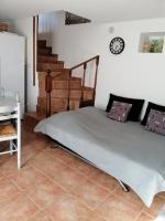 a bedroom with a bed and a clock on the wall at Sarrola-Carcopino Gîte en Pierre in Sarrola-Carcopino