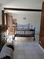 a bedroom with a black bed in a room at Sarrola-Carcopino Gîte en Pierre in Sarrola-Carcopino