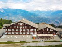 a large brown building with white birds in front of it at Etoile De Neige in Pila