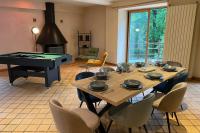 a dining room with a table and a piano at Ancien Moulin rénové à neuf pour 20 personnes sur les rives du Trieux in Plésidy