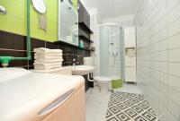 a white bathroom with a sink and a toilet at Apartman Ema Dobropoljana in Dobropoljana