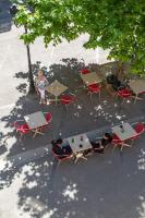 an overhead view of tables and chairs and a tree at Hôtel Le Relais de Poste Arles Centre Historique in Arles