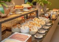 a buffet with different types of bread and other foods at Porto Kaeté Hotel in Maceió