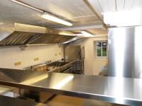 a large kitchen with a large stainless steel counter top at Chata Mísečky in Horni Misecky