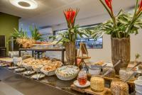 a buffet with bread and pastries on a table at Porto Kaeté Hotel in Maceió