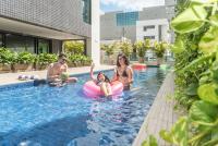 a group of people sitting in a swimming pool at Porto Kaeté Hotel in Maceió