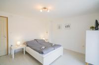 Posteľ alebo postele v izbe v ubytovaní Zigzag Apartman
