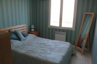 a bedroom with a bed and a window and a mirror at Holiday Home With Pool In Marseillan in Marseillan