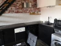 a kitchen with black cabinets and a sink and a dishwasher at Studio with large balcony and nice view by Weekome in Vallauris