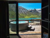 a hot tub on a deck with a view of a mountain at Langley Hôtel Tignes 2100 in Tignes