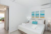A bed or beds in a room at Waves Apartments Melody Glyfada