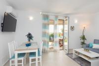 A television and/or entertainment centre at Waves Apartments Melody Glyfada