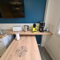 a counter in a kitchen with a wooden counter top at T2 GUYNEMER RDC WIFI Plage à 80m Linge de lit fourni in Les Sables-d&#39;Olonne