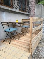 a wooden table and two chairs on a patio at Appartement au cœur du Val d&#39;Argent in Sainte-Croix-aux-Mines