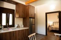 a kitchen with a sink and a refrigerator at flamingo colour valey house in Palekastron