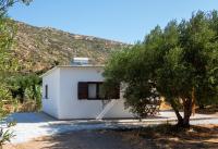 a white house with a tree in front of it at flamingo colour valey house in Palekastron