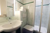 a bathroom with a sink and a toilet and a shower at Hôtel la Capelle Millau in Millau