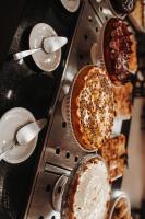 a table with plates of food and spoons at Spazio Marine Hotel - Guaratuba in Guaratuba