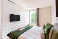 a bedroom with a large bed with a tv on the wall at CMG BASTILLE &#47; GARE DE LYON 2 in Paris