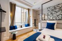 a bedroom with a bed with blue pillows and a window at CMG BASTILLE &#47; GARE DE LYON 2 in Paris