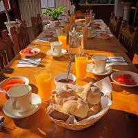 Una mesa larga con pan y vasos de jugo de naranja. en Hotel Chinguirito, en Villa del Carbón
